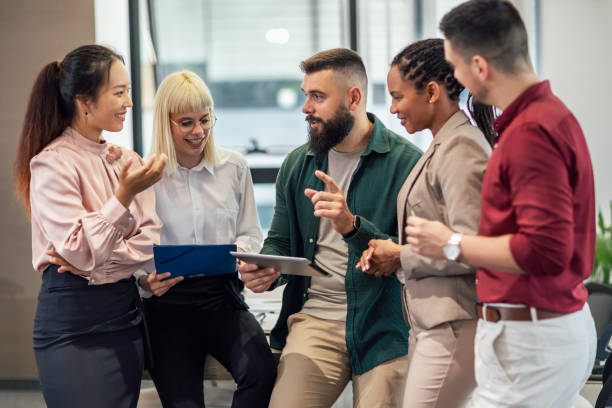 istock A business team is standing in a modern office and having a discussion 1641851963