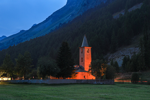 San Lurench church in Sils in Engadin village with illumination during blue hour. Swiss Alps, Switzerland, Europe.