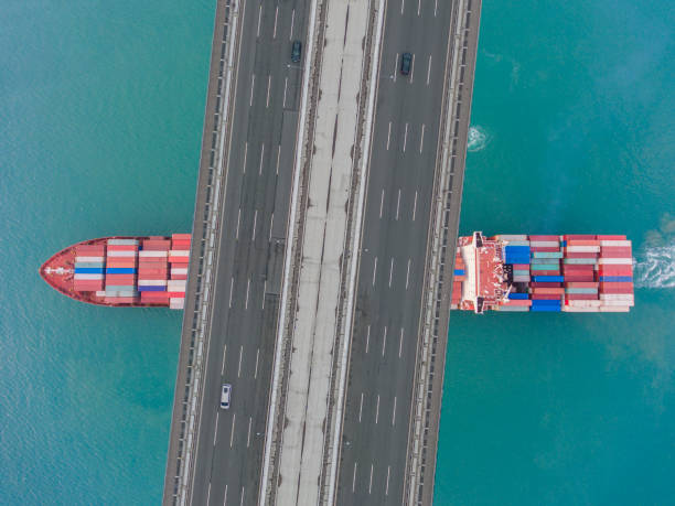 istock Aerial view of a cargo ship passing under bridge. 1641859131