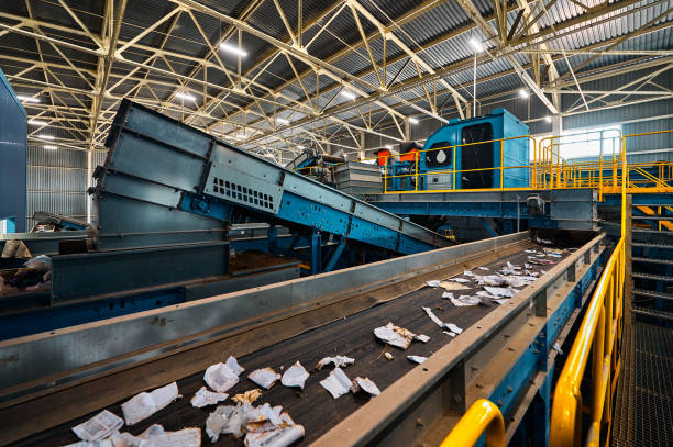 Conveyors carry trash and empty platforms at recycling plant