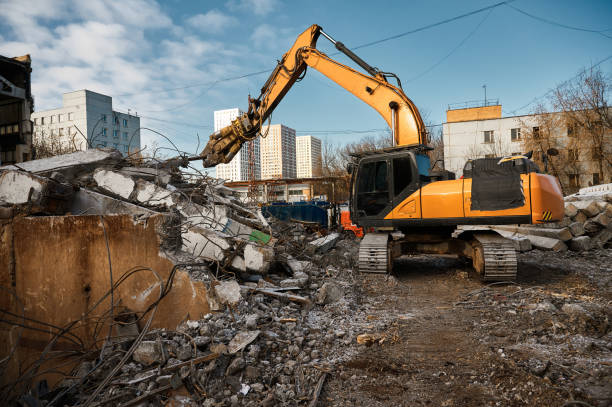 istock Excavator with hydraulic scissors cuts concrete beams 1641874024