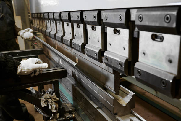 istock Bending press operates with metal sheet in plant workshop 1641874027