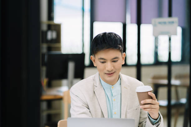 istock Businessman using laptop computer in office. Happy man, entrepreneur, small business owner working online. 1641892074