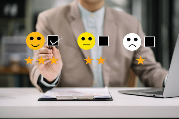 istock Male businessman holding a digital tablet with checkboxes rating smiley faces excellent for Satisfaction Survey, Happy Client Customer Experience concept. 1641892084