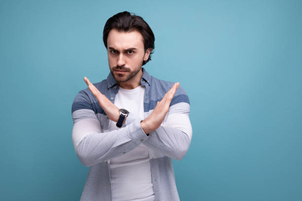 istock young brunette man in model appearance with crossed arms on studio background 1641893668
