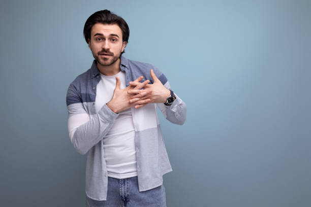 istock young brunette man in sweater posing on studio background 1641894178