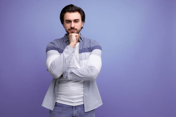istock pensive brunette guy in a model appearance dreams on a studio background 1641894186