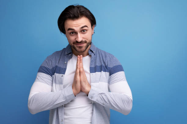 istock hopeful young brutal brunette guy on studio background 1641894555