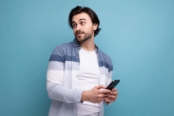 istock young brunette man uses wire transfer on smartphone 1641894738