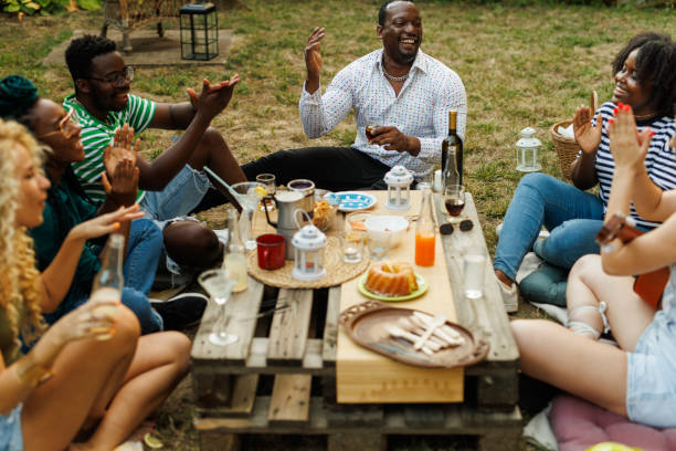 istock Friends hanging out, enjoying drinks and snacks during a picnic 1641903386