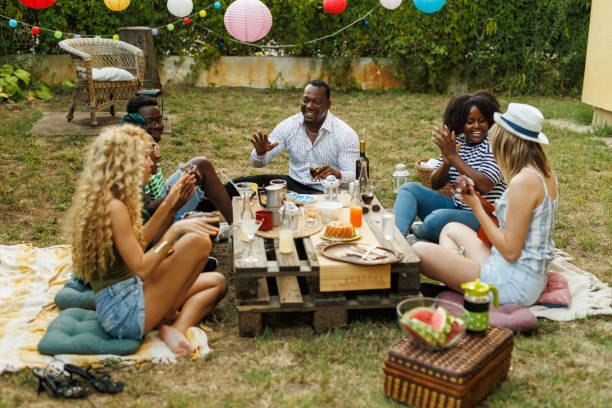 istock Friends hanging out, enjoying drinks and snacks during a picnic 1641903392