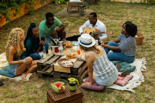 istock Friends hanging out, enjoying drinks and snacks during a picnic 1641903402