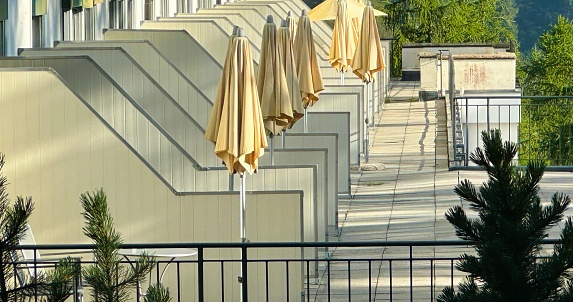 Terrace with a set of closed umbrellas