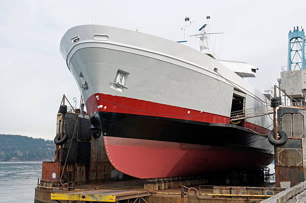 bulk head of the commercial ship sitting on floating dry dock yard, recondition, repairing, painting overhaul in dock yard terminal