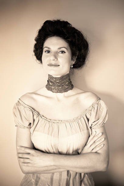 Portrait of a young caucasian woman with lace on her neck. Photo is in retro style imitating times around 1910.