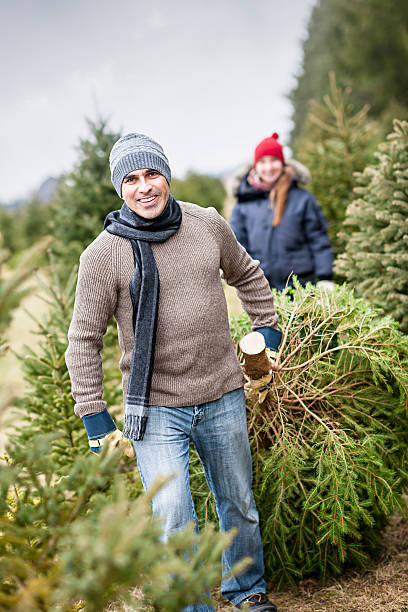 Family with Christmas tree on a farm