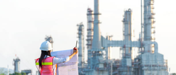 istock Engineers woman holding blueprint and report schedule for workers security control at power plant energy industry. Engineer and industry Concept, copy space for banner 1641964946