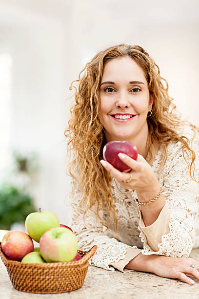 istock Smiling woman holding apple 164196575