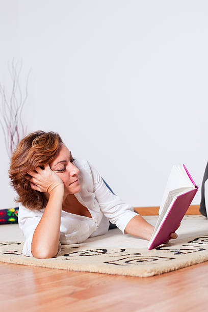 istock Woman reading books 164197360