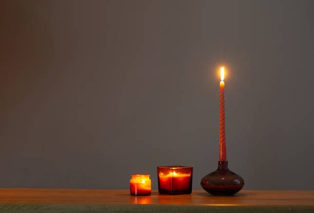 istock burning candles in glass candlesticks on dark background 1642002886