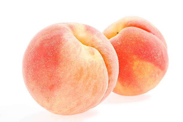 Two whole peaches on a white background Peaches Isolated on White peach photos stock pictures, royalty-free photos & images