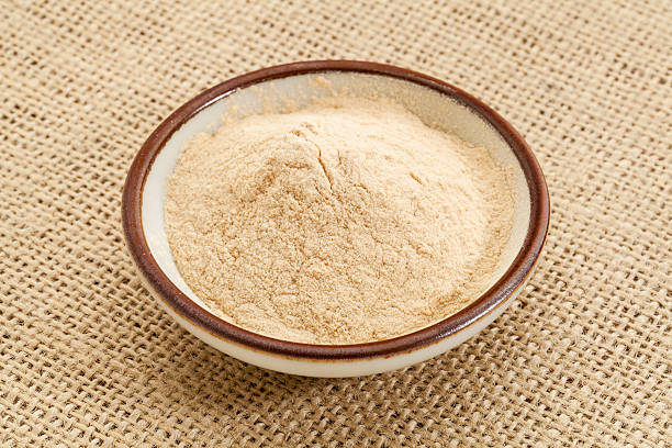 baobab fruit powder small ceramic bowl of African baobab fruit powder against burlap canvas superfruit stock pictures, royalty-free photos & images