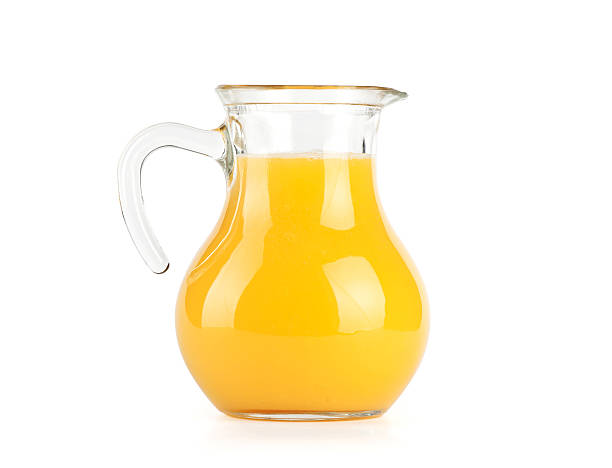 Orange juice in pitcher. Isolated on white background Orange juice in pitcher. Isolated on white background jug stock pictures, royalty-free photos & images