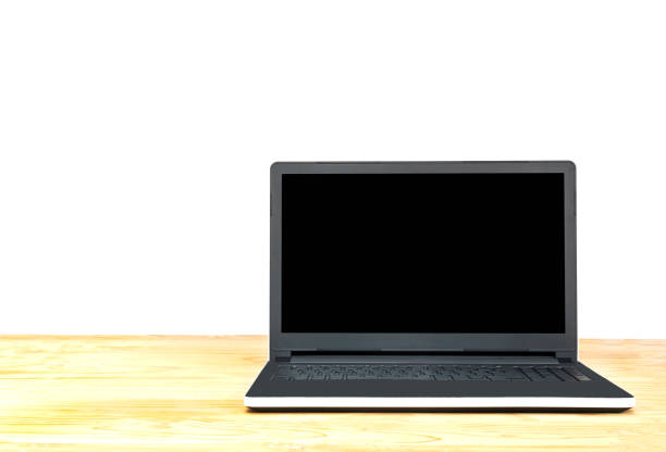 Laptop on table top isolated over white background. Photo includes CLIPPING PATH of blank screen.