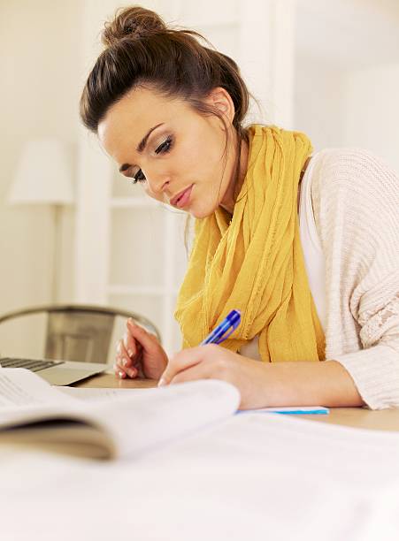 istock Indoor Woman Studying at Home Writing Something 164210311