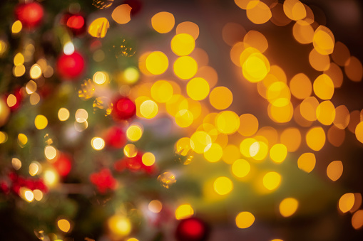 Defocused Christmas lights and baubles background. Predominant colors are yellow and red. High resolution 42Mp studio digital capture taken with SONY A7rII and Canon EF 70-200mm f/2.8L IS II USM Telephoto Zoom Lens