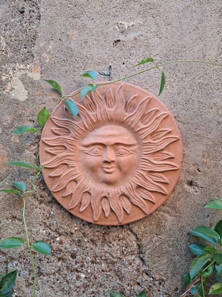 istock Clay tile with the symbol of the sun 1642136302