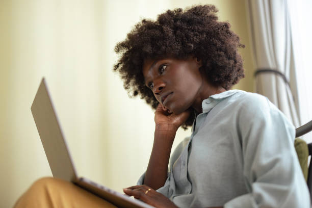 istock Bored African American Woman Using a Laptop Computer for Work 1642150208