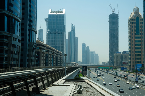 Dubai, UAE - December 1, 2023: View of the roadside from car windshield to Dubai city, United Arab Emirates. High quality photo