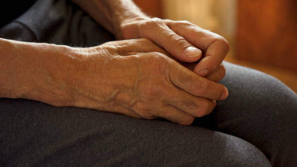 istock The older man's hands are on his knees, waiting. 1642185313