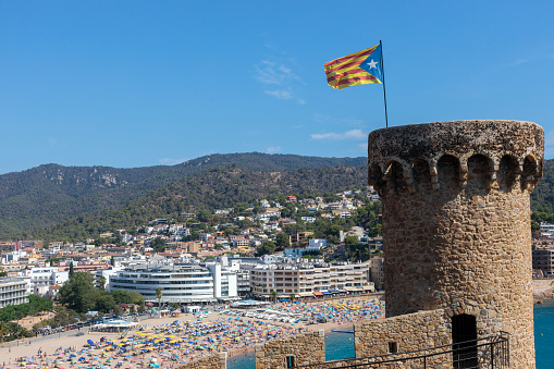 Tossa De Mar, Spain - 12 August 2023 Tossa de Mar, the tower with Catalonia flag in histric old town of Costa Brava.