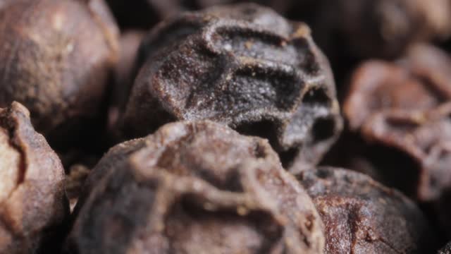 Peppercorns or black pepper spice. Super Macro Close Up.