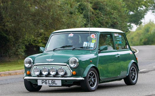This is a 1974 Classic Mini Cooper Innocenti 1300 Export.  This is a front view of the whole car on the owners drive.