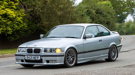 Whittlebury,Northants,UK -Aug 26th 2023: 1998 silver BMW 3 series 328i coupe car travelling on an English country road