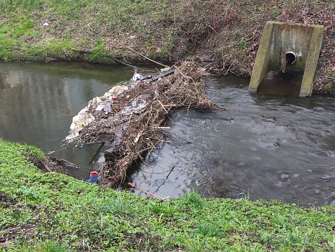 Dam made of branches and debris on small river