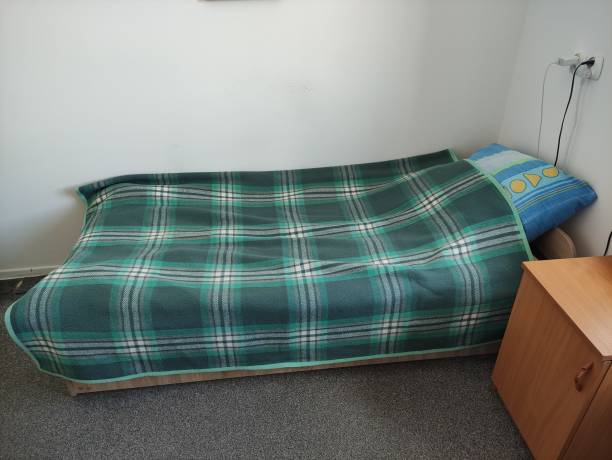 istock Bed in student room in campus. A room in the student hostel. 1642330358