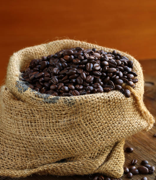 istock coffee beans in a canvas bag on a wooden background 1642355757
