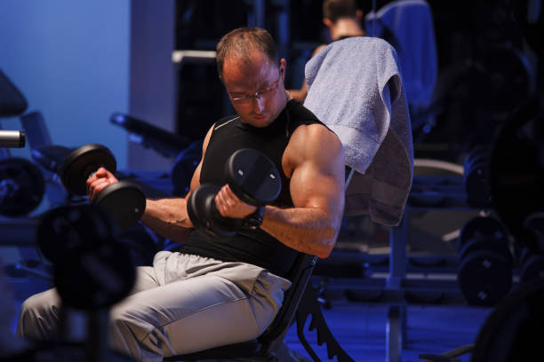 istock Fitness model pushing up the dumbbells 1642356322