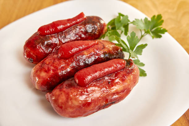 istock Fried sausages with ketchup on a white plate. 1642364356