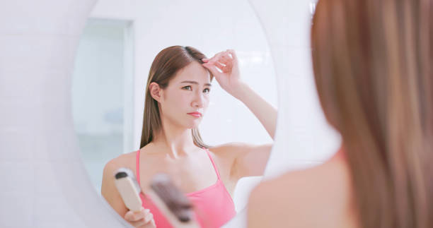 istock woman worry about hair loss 1642368387