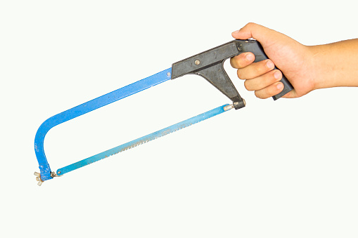 Hand holding hacksaw, background on white