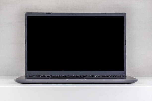 istock black mock-up on a laptop screen on a white table against a gray wall close-up front view 1642377860