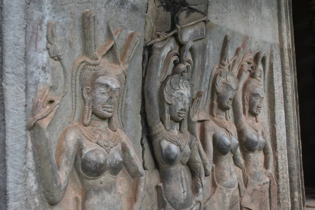 Row of Bare-Breasted Apsara Relief Sculptures at Angkor Wat stock photo