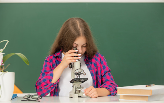 child study with microscope on blackboard background, science.