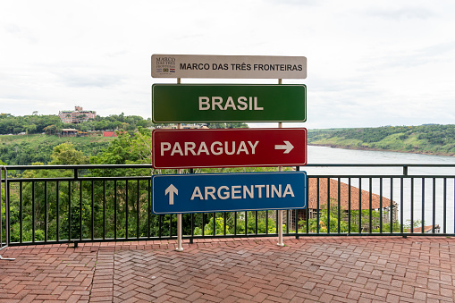 State of Parana, Brazil - January 14, 2023: The sign indicating the direction of Brazil, Paraguay and Argentina, a tri-border area along the junction, State of Parana, Brazil.