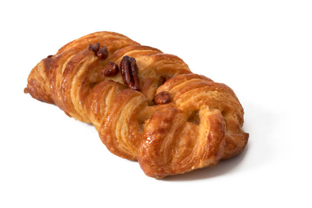 istock Twisted cake with walnuts and filling inside, isolated on white background. 1642416487